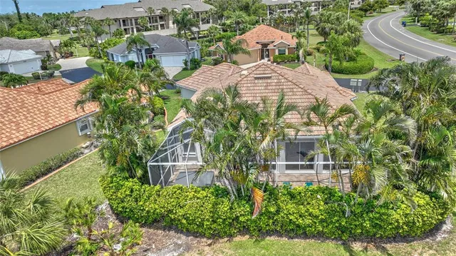 an aerial view of a house with yard and lake view