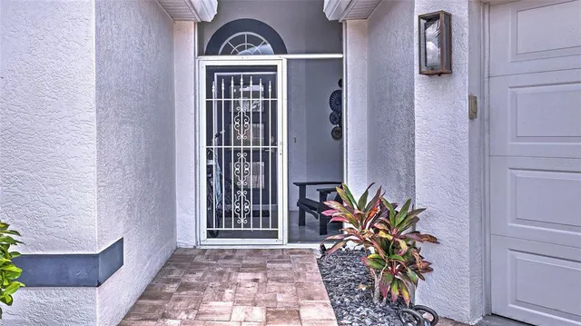 an entryway with a flower pot and a window