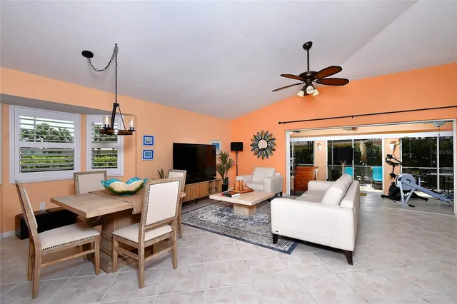 a living room with furniture a flat screen tv and a large window