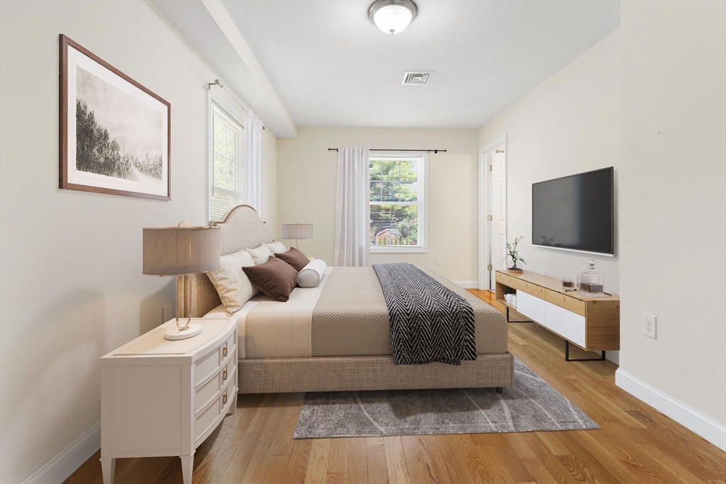 403-405 Reedsdale Road Milton, MA 02186 - Photo 8 of 21 a bedroom with a bed and a flat screen tv
