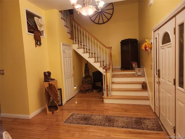 a view of entryway and hall with wooden floor