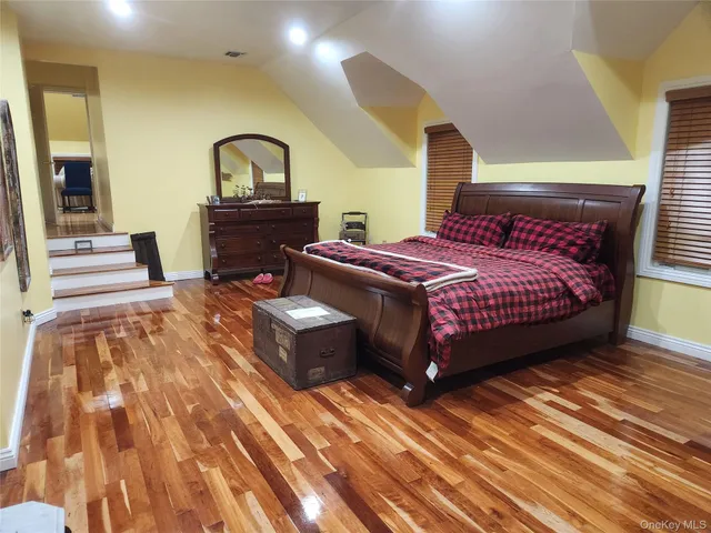 a bedroom with a bed and window