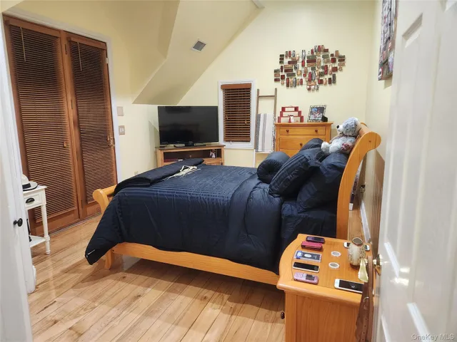 a bedroom with a bed and a flat screen tv