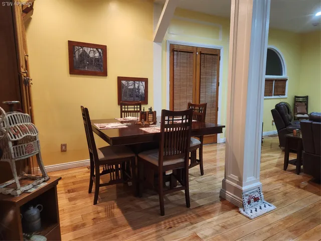 a view of a dining room with furniture and wooden floor