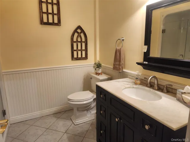 a bathroom with a sink vanity and a toilet