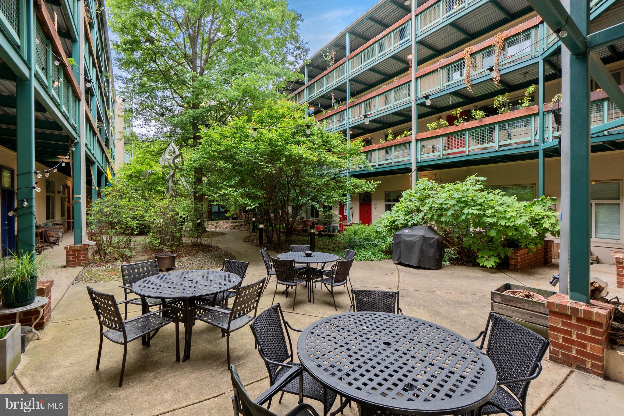 7981 Eastern Avenue Northwest, Unit 219 Silver Spring, MD 20910 - Photo 3 of 45 Common patio with grill and fire pit