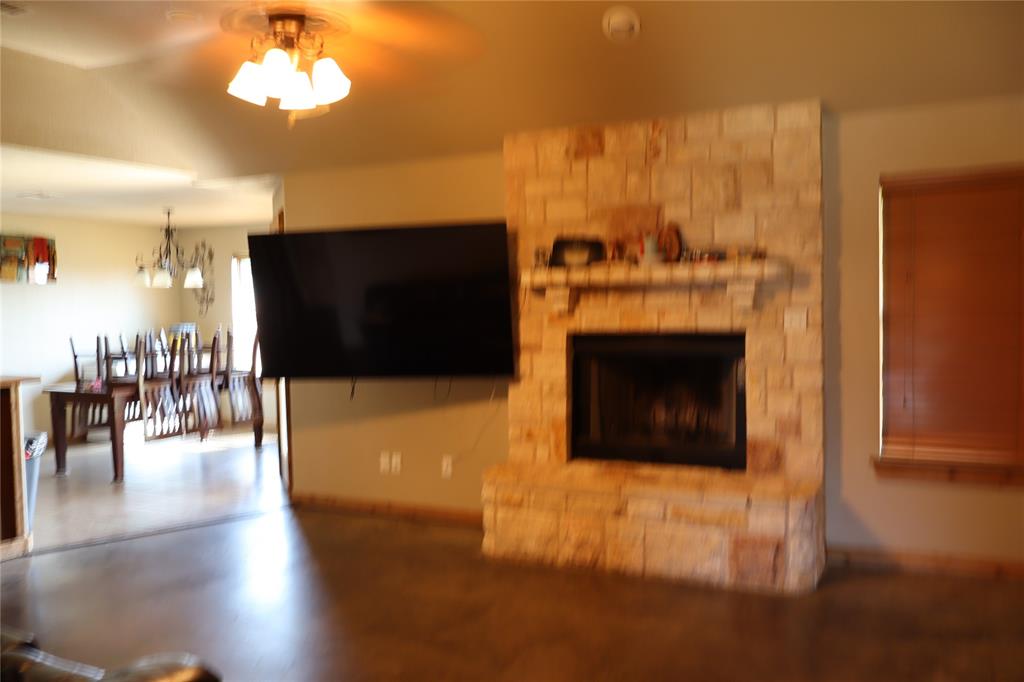 902 El Campo Drive Rio Vista, TX 76093 - Photo 6 of 11 a living room with furniture a flat screen tv and a fireplace