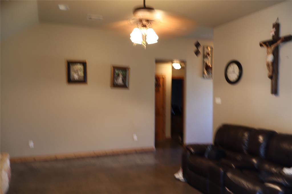 902 El Campo Drive Rio Vista, TX 76093 - Photo 10 of 11 a living room with couch and a chandelier