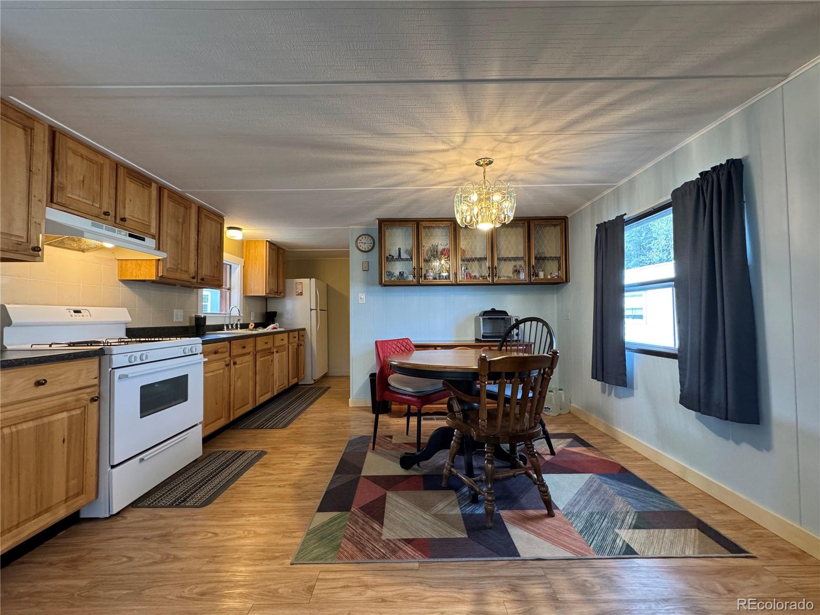 910 J Street, Unit F2 Salida, CO 81201 - Photo 4 of 18 a view of a dining room with furniture and chandelier