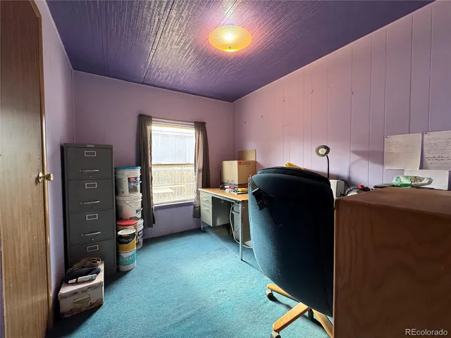 a view of workspace with furniture and window