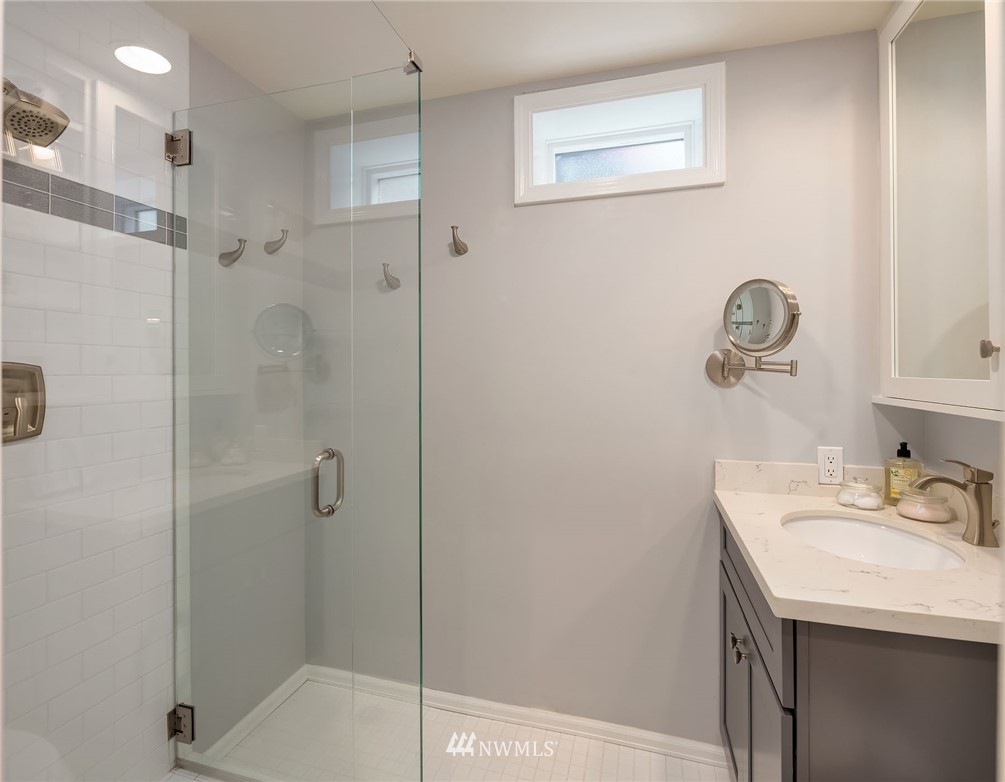 7581 Old Redmond Road, Unit 1 Redmond, WA 98052 - Photo 13 of 19 a bathroom with a shower sink and a mirror