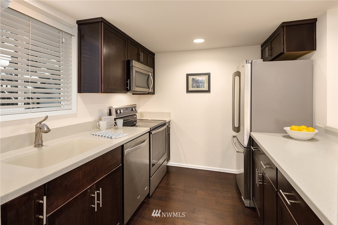 7581 Old Redmond Road, Unit 1 Redmond, WA 98052 - Photo 7 of 19 a kitchen with a sink and a refrigerator