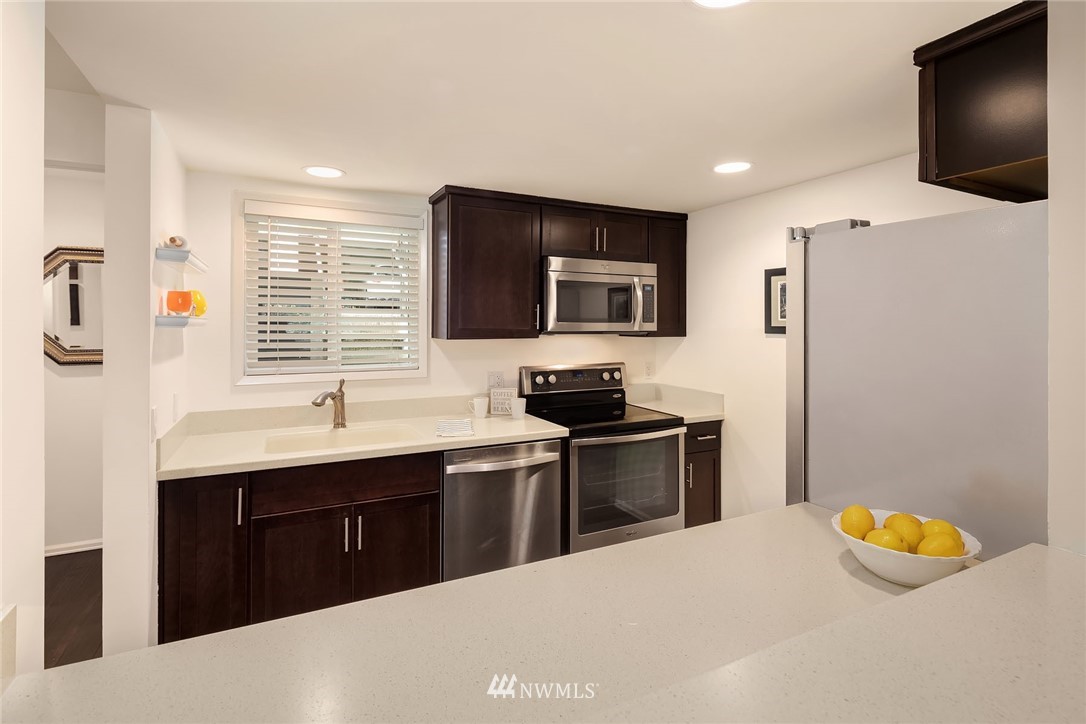 7581 Old Redmond Road, Unit 1 Redmond, WA 98052 - Photo 8 of 19 a kitchen with stainless steel appliances a stove sink and microwave