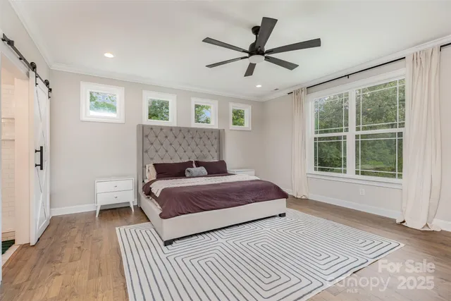 a bedroom with a large bed and a window