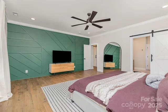 a bedroom with a large bed and a large mirror