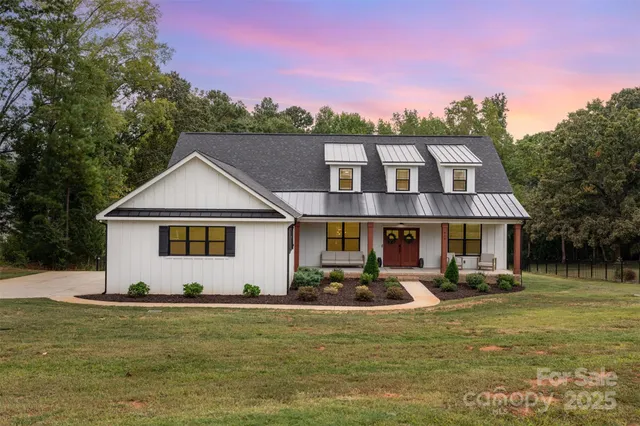a front view of a house with a yard table and chairs