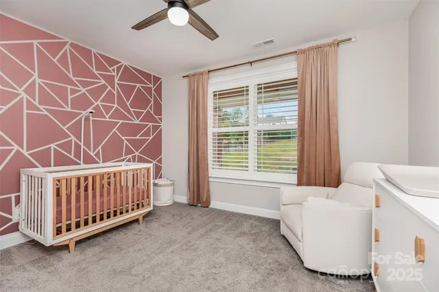 a bed room with a bed and a chair