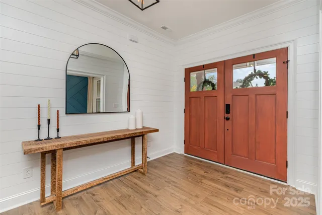 a view of a livingroom with furniture and mirror