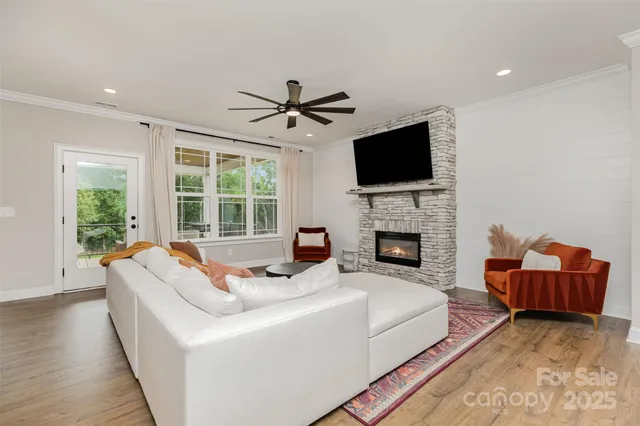 a living room with furniture fireplace and flat screen tv