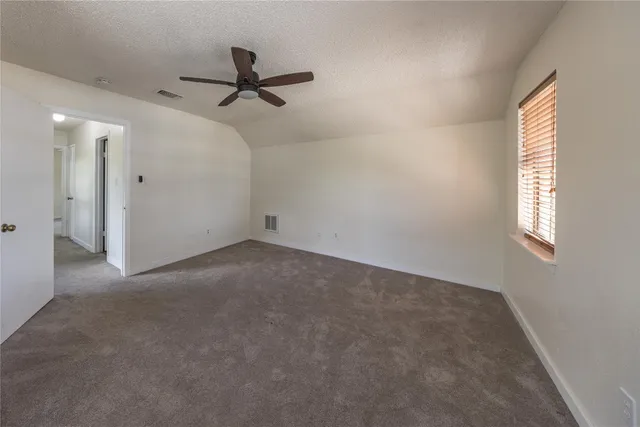 a view of a livingroom with a ceiling fan and window