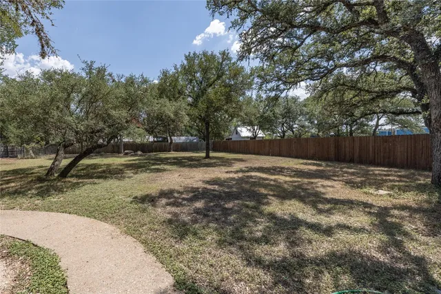 a backyard of a house with large trees