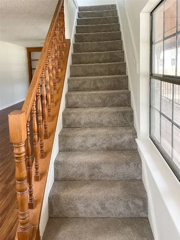 a view of staircase with white walls