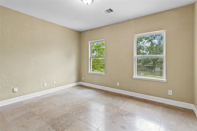 a bathroom with a toilet tub and shower