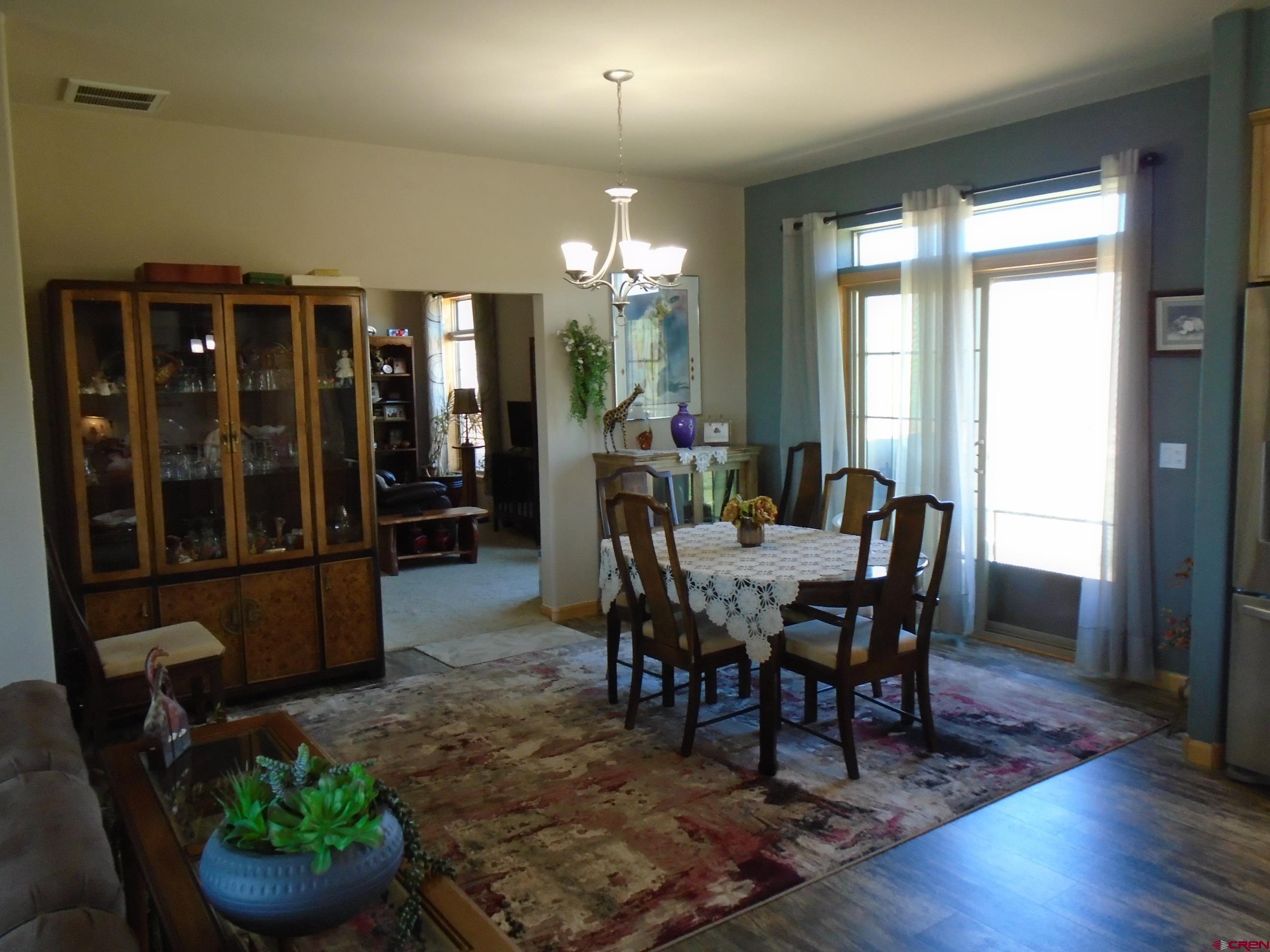 23041 T Road Cedaredge, CO 81413 - Photo 12 of 28 a view of a dining room with furniture and chandelier
