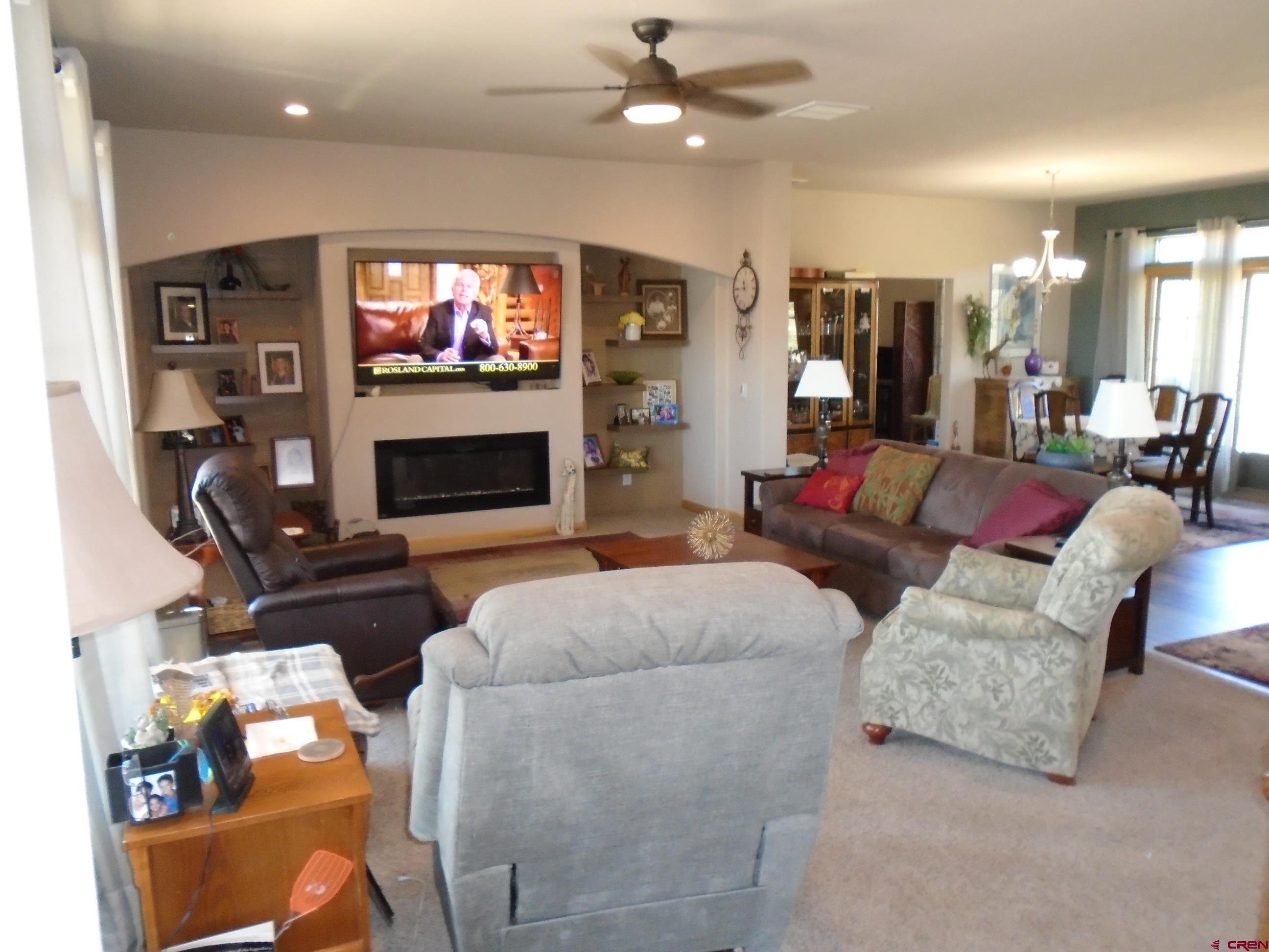 23041 T Road Cedaredge, CO 81413 - Photo 13 of 28 a living room with furniture a flat screen tv and a fireplace
