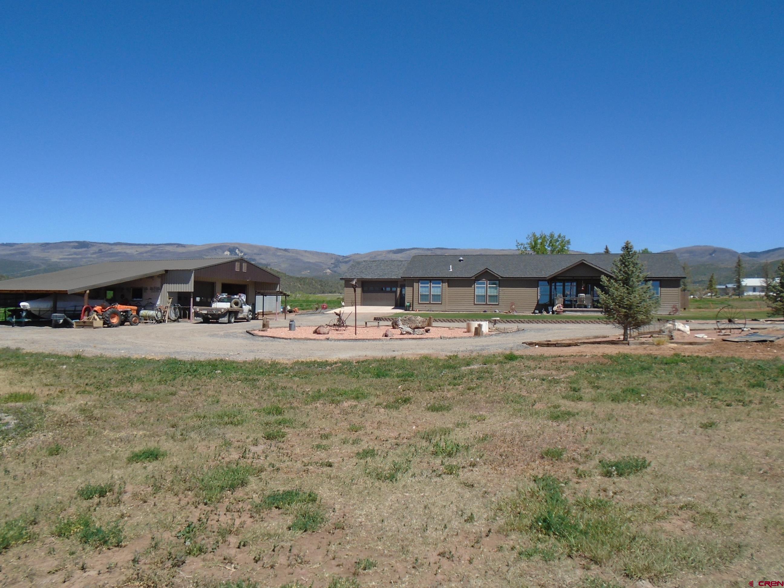 23041 T Road Cedaredge, CO 81413 - Photo 2 of 28 a view of a yard with an outdoor seating