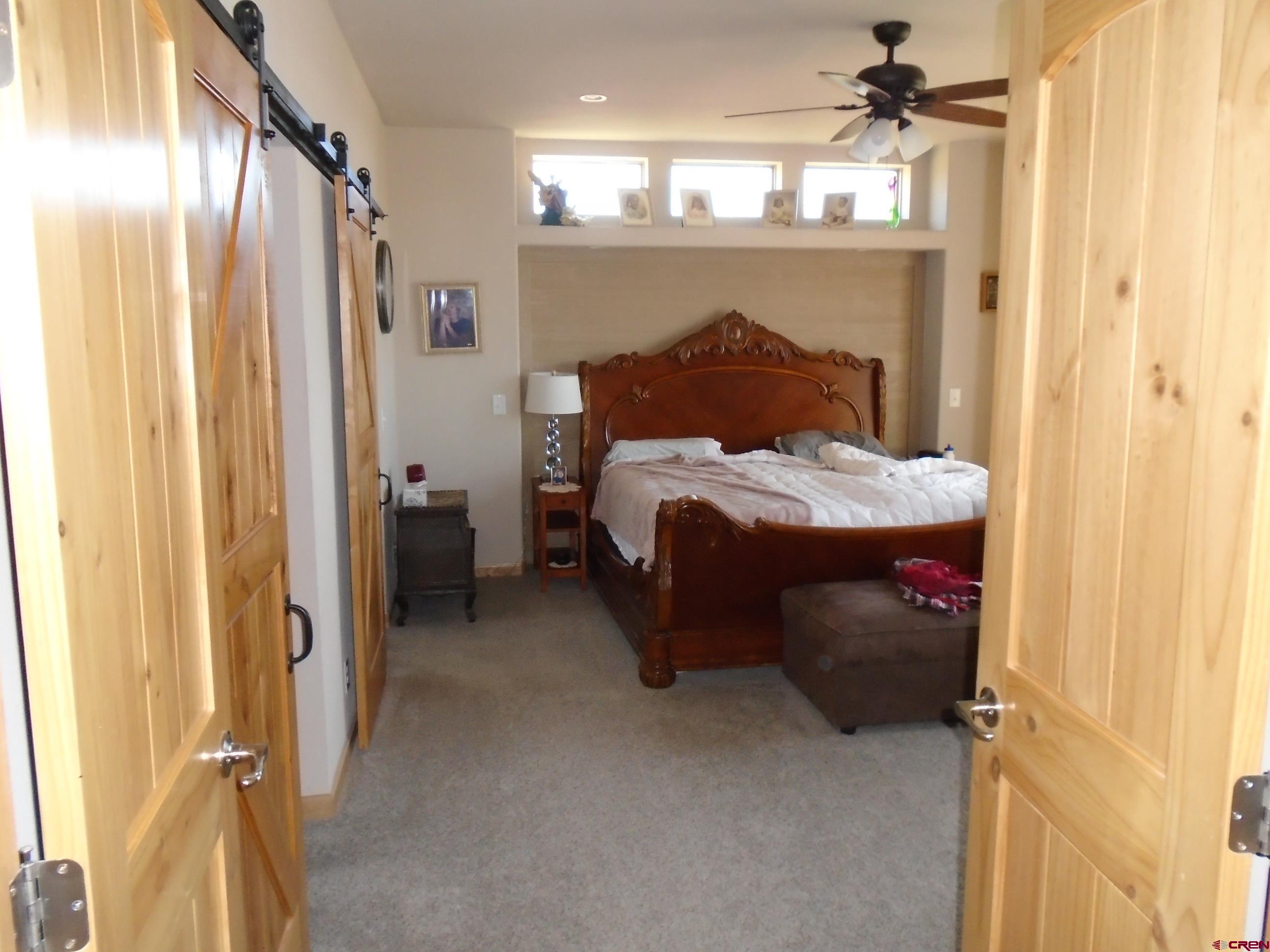 23041 T Road Cedaredge, CO 81413 - Photo 25 of 28 a bedroom with a bed closet and a mirror