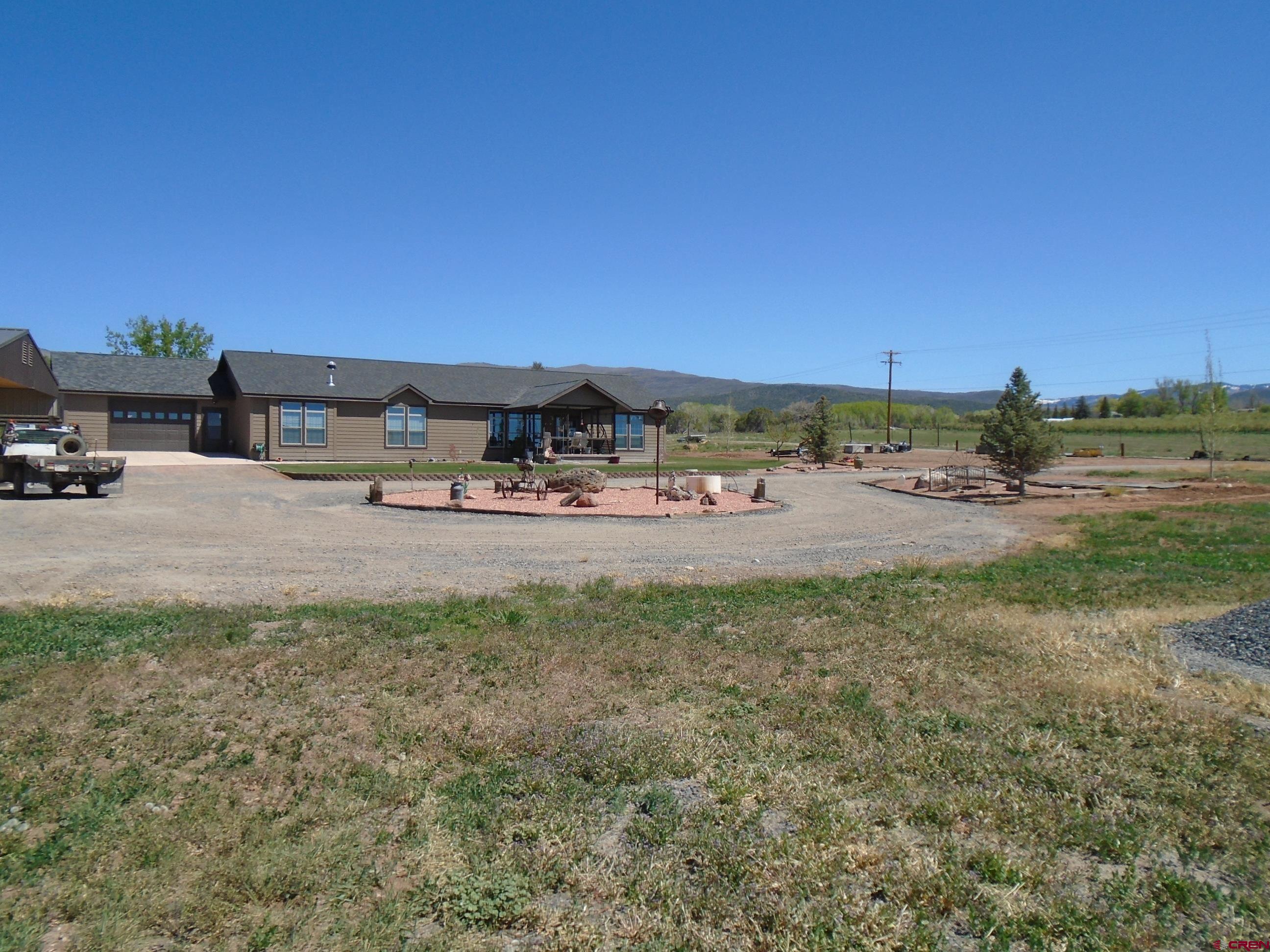23041 T Road Cedaredge, CO 81413 - Photo 3 of 28 a view of a dirt road with a building in the background
