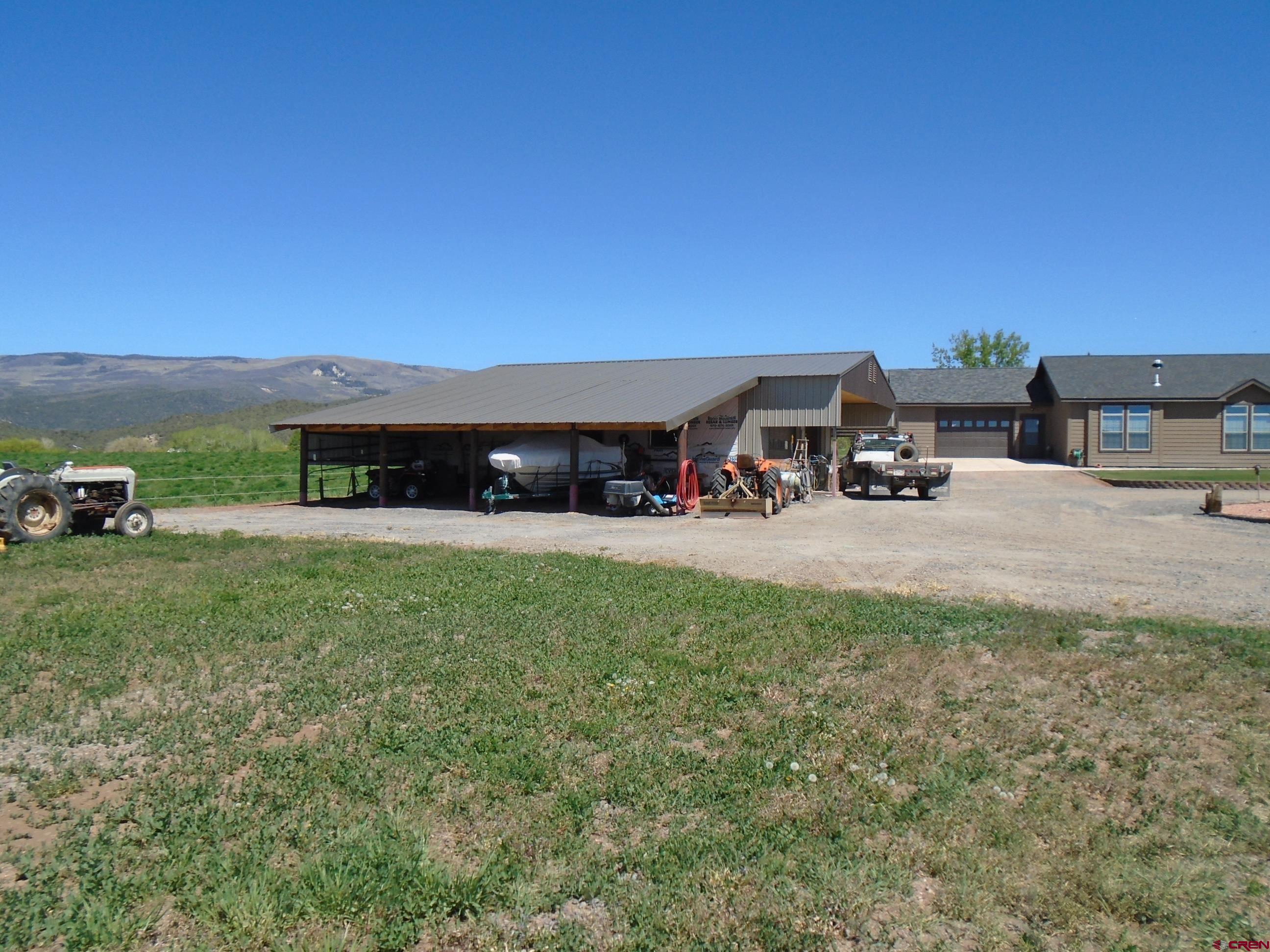 23041 T Road Cedaredge, CO 81413 - Photo 4 of 28 a view of a house with a yard porch and sitting area