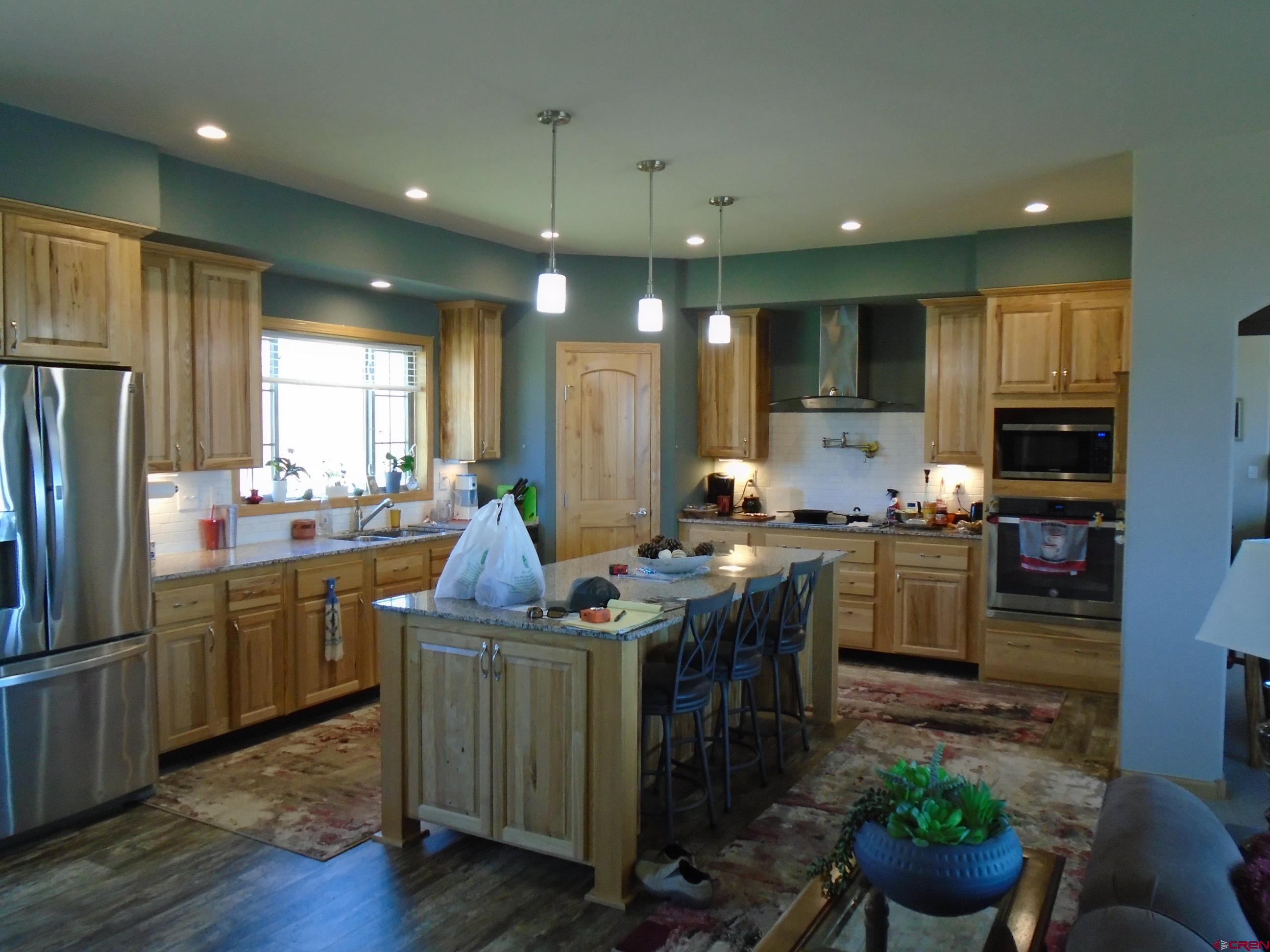 23041 T Road Cedaredge, CO 81413 - Photo 10 of 28 a kitchen with kitchen island granite countertop lots of counter top space