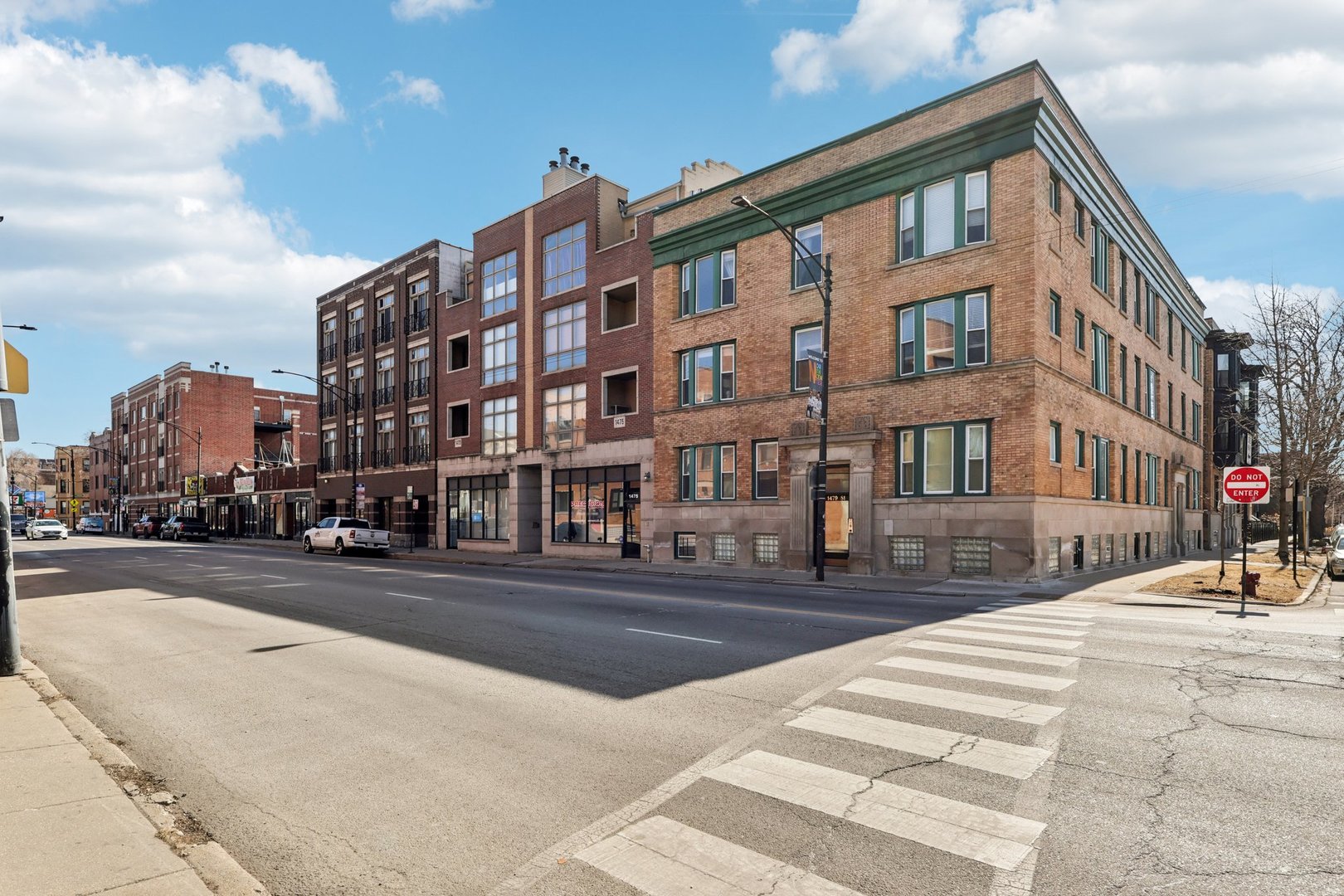 1473 West Irving Park Road, Unit 4E Chicago, IL 60613 - Photo 1 of 44 a city street lined with buildings and trees