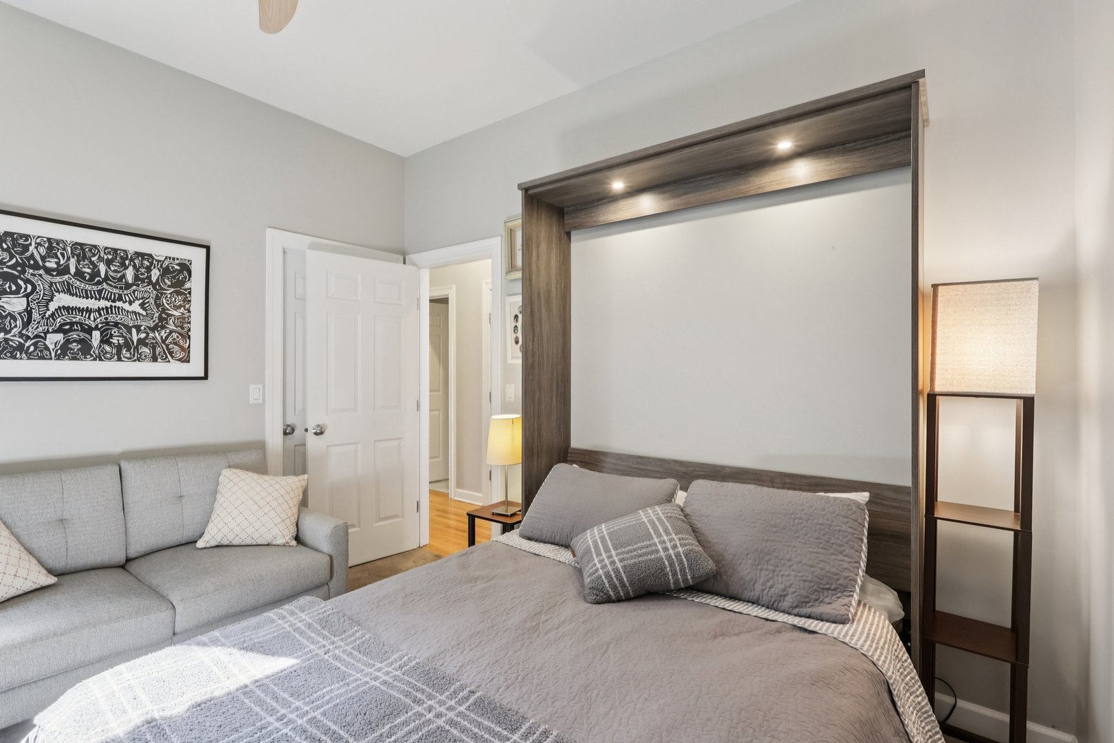 1473 West Irving Park Road, Unit 4E Chicago, IL 60613 - Photo 16 of 44 a bedroom with a large bed and a large mirror