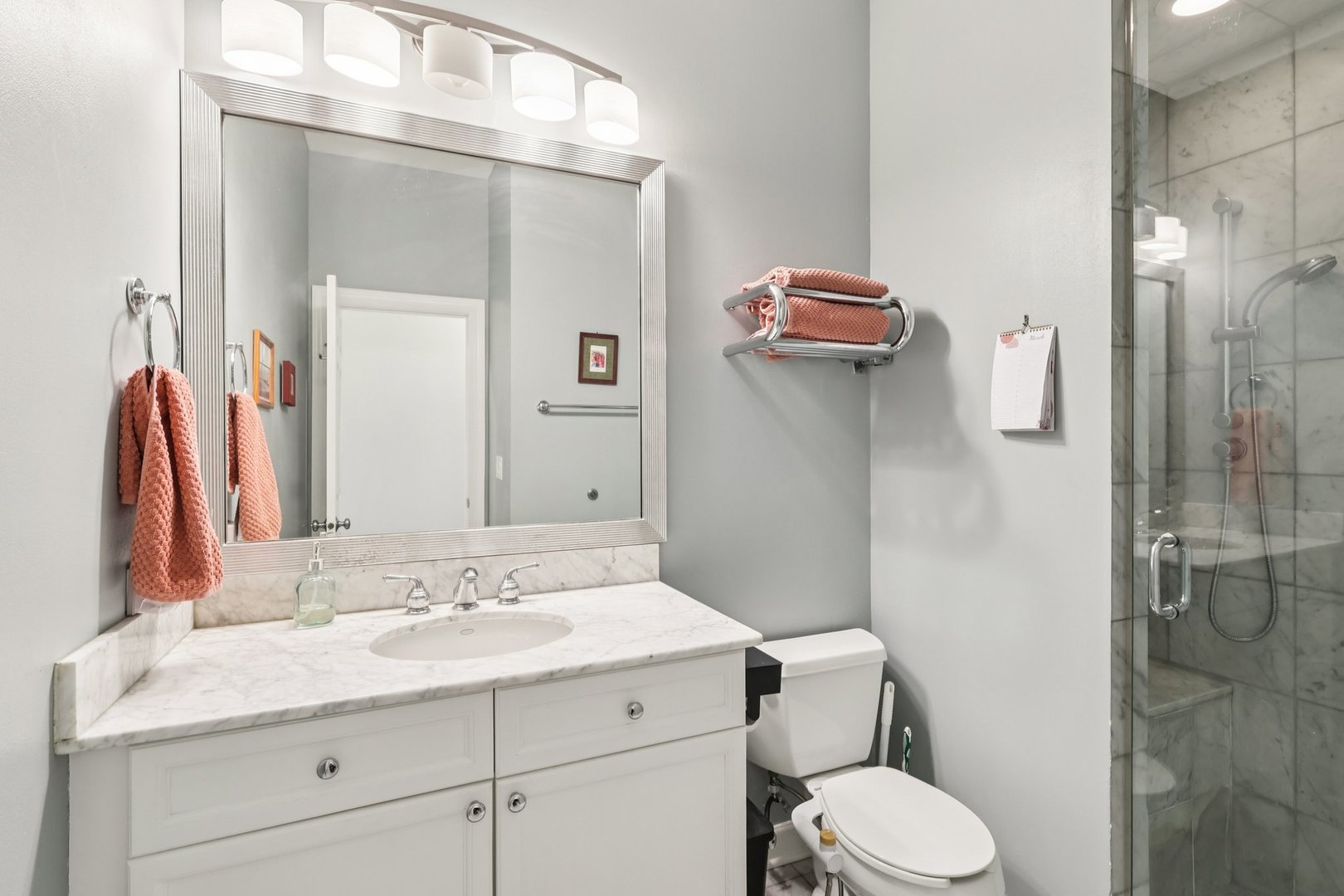 1473 West Irving Park Road, Unit 4E Chicago, IL 60613 - Photo 17 of 44 a bathroom with a granite countertop sink toilet and shower