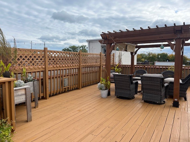 1473 West Irving Park Road, Unit 4E Chicago, IL 60613 - Photo 44 of 44 a view of a roof deck with table and chairs