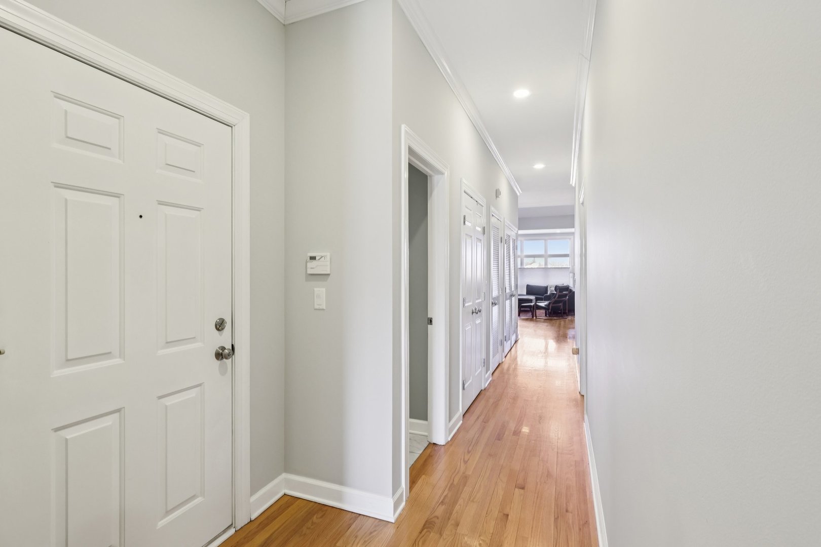 1473 West Irving Park Road, Unit 4E Chicago, IL 60613 - Photo 5 of 44 a view of a hallway with a wooden floor