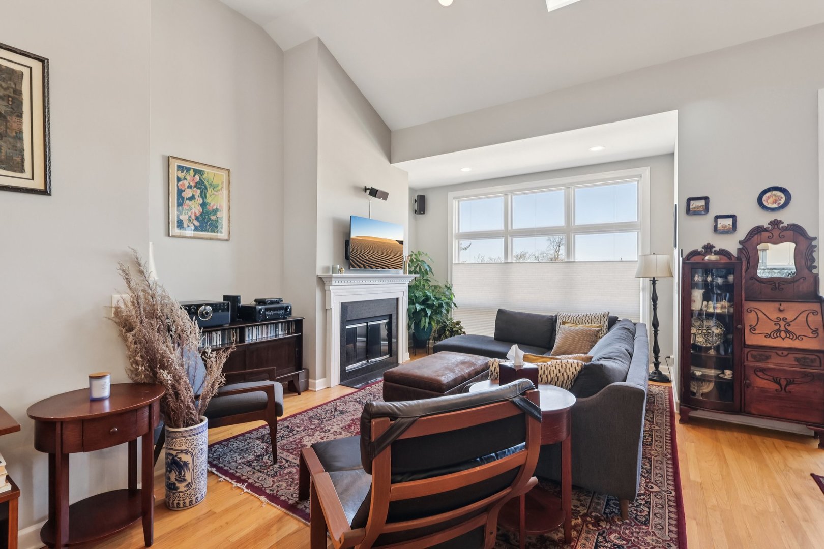1473 West Irving Park Road, Unit 4E Chicago, IL 60613 - Photo 7 of 44 a living room with furniture a fireplace and a flat screen tv