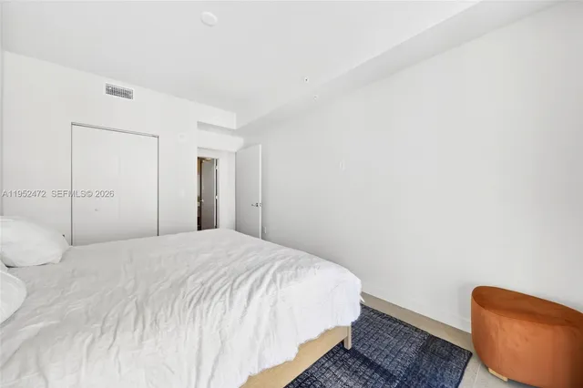 a large bed in a white room