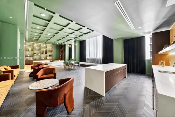 a living room with lots of furniture and a potted plant