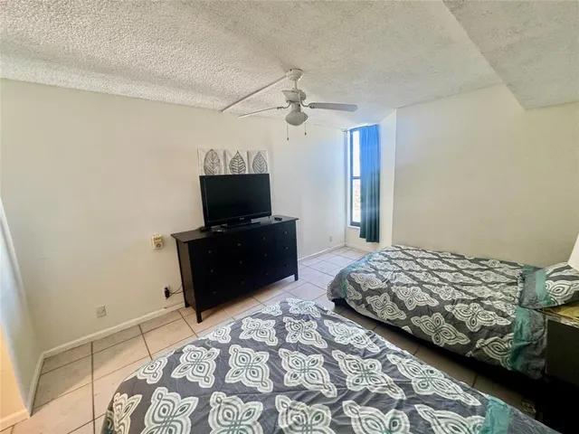 a bedroom with bed and flat screen tv