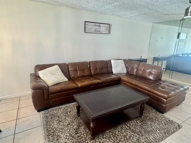 a living room with a couch and a rug