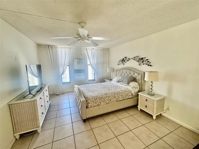 a bedroom with a bed and a flat tv screen on the dresser