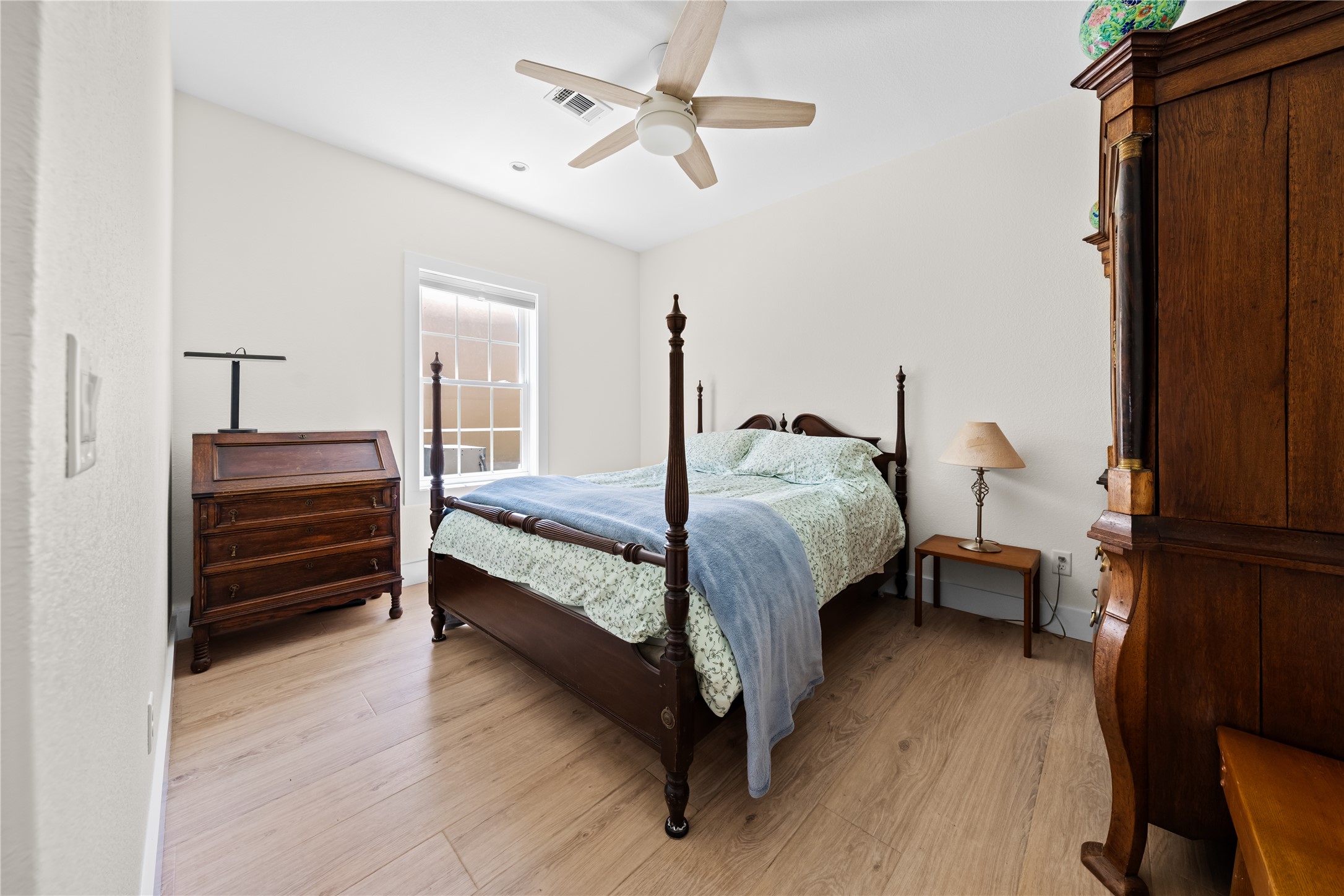 7670 Nez Perce Trace Manor, TX 78653 - Photo 28 of 40 Bedroom with light wood-style flooring, ceiling fan, and visible vents