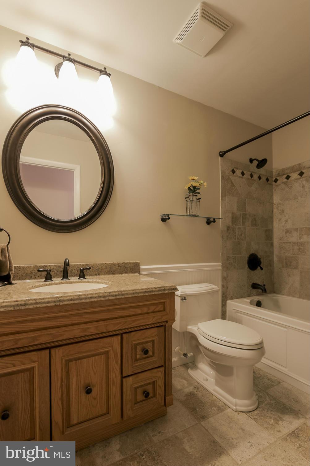 1111 Peachtree Road Fallston, MD 21047 - Photo 23 of 30 a bathroom with a granite countertop toilet a sink and a mirror