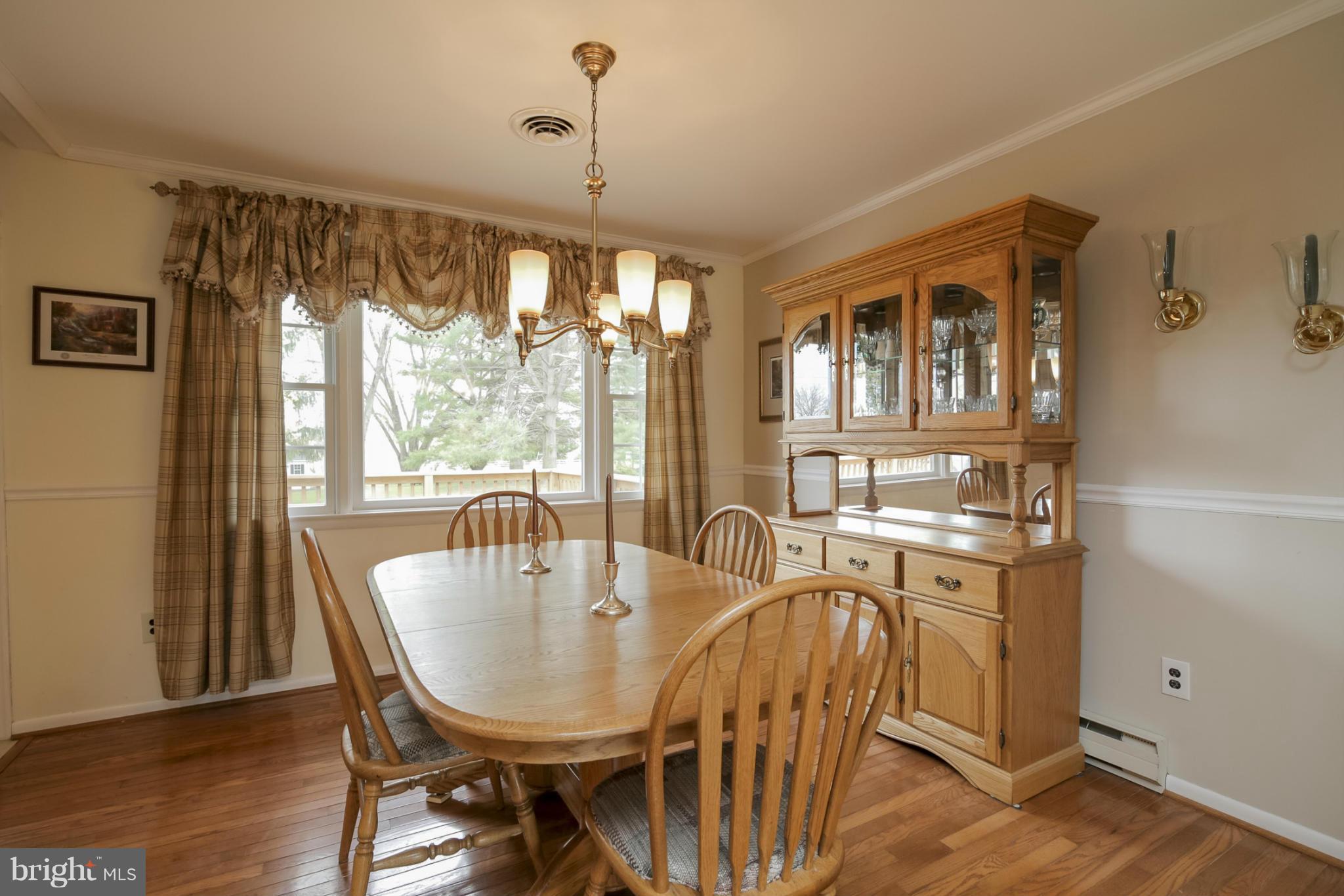 1111 Peachtree Road Fallston, MD 21047 - Photo 6 of 30 a dining room with furniture a chandelier and wooden floor