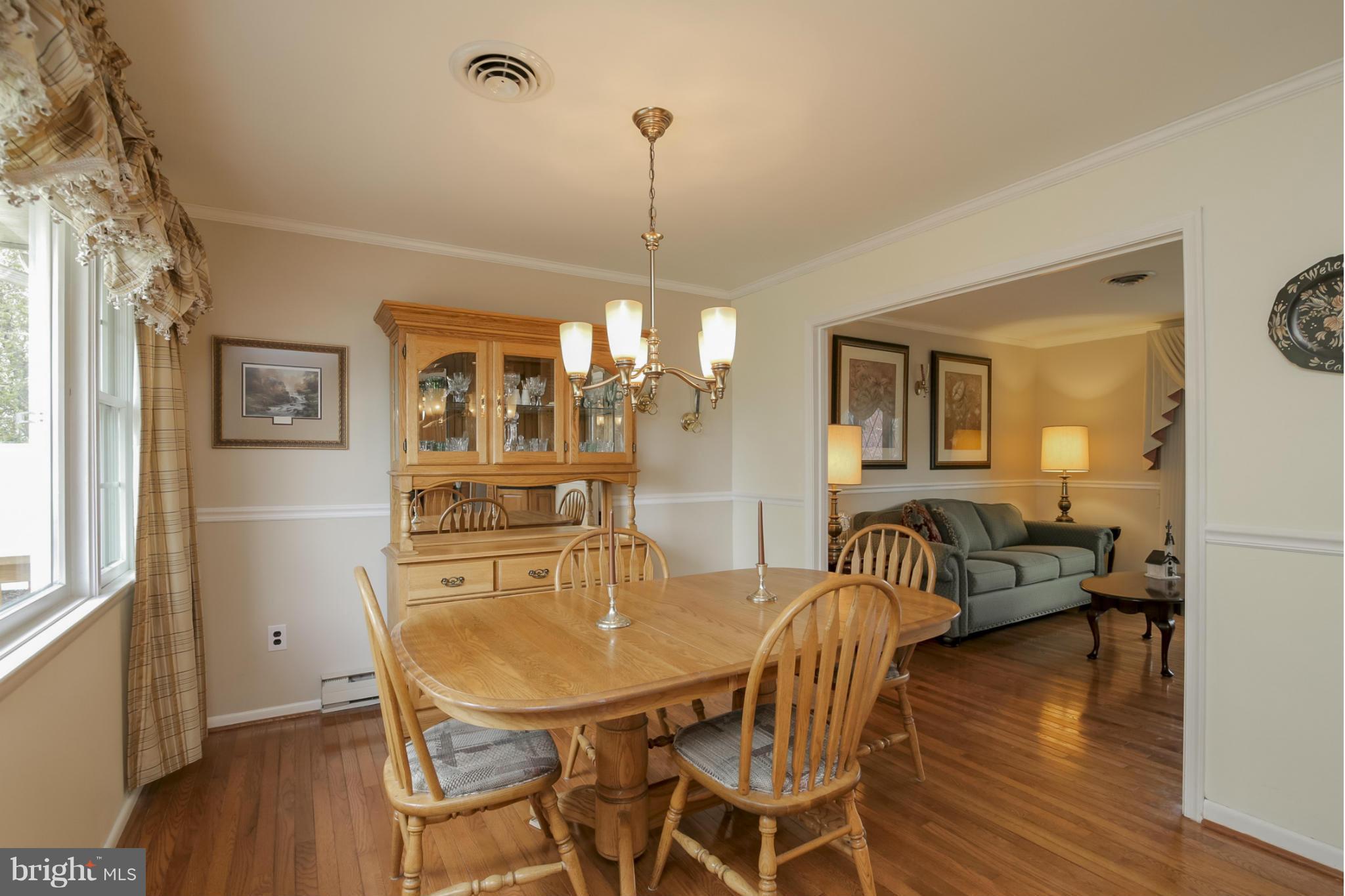 1111 Peachtree Road Fallston, MD 21047 - Photo 7 of 30 a dining room with furniture a chandelier and wooden floor