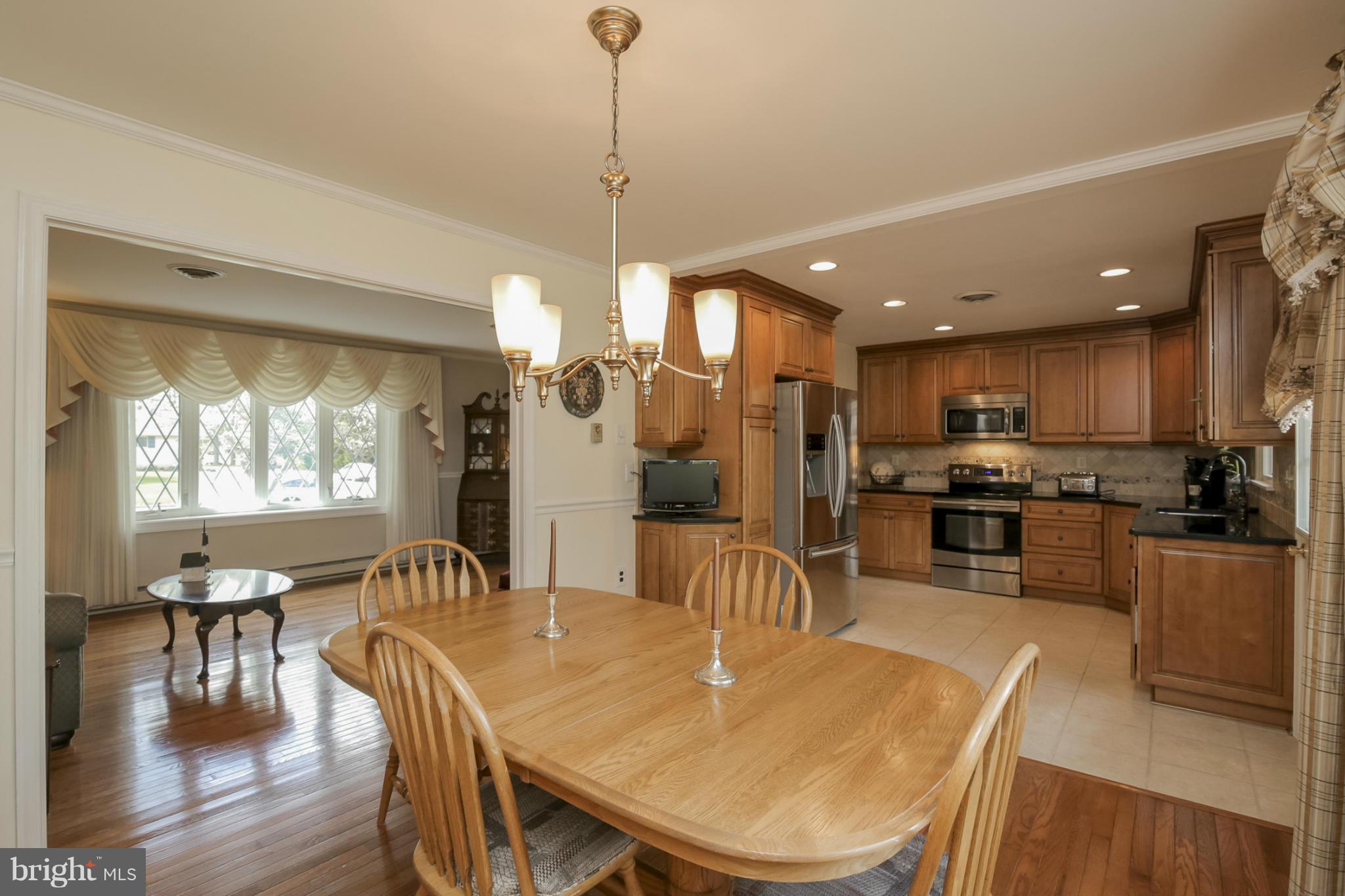 1111 Peachtree Road Fallston, MD 21047 - Photo 8 of 30 a view of a dining room and livingroom with furniture wooden floor a chandelier